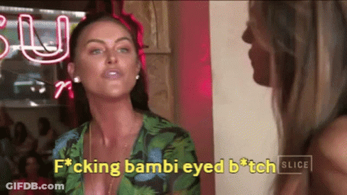 Two Women Are Standing Next To Each Other In Front Of A Neon Sign That Says Slice GIF