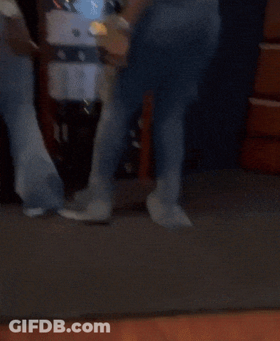 Two Women Are Standing Next To Each Other In Front Of A Rack Of Electronic Equipment . GIF
