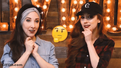 Two Women Are Standing Next To Each Other In Front Of A Sign That Says Tumblr GIF