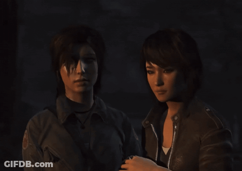 Two Women Are Standing Next To Each Other In The Dark GIF