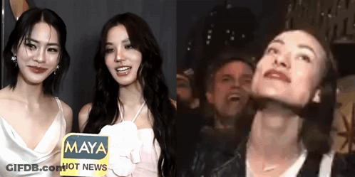 Two Women Are Standing Next To Each Other With A Sign That Says Maya Hot News . GIF