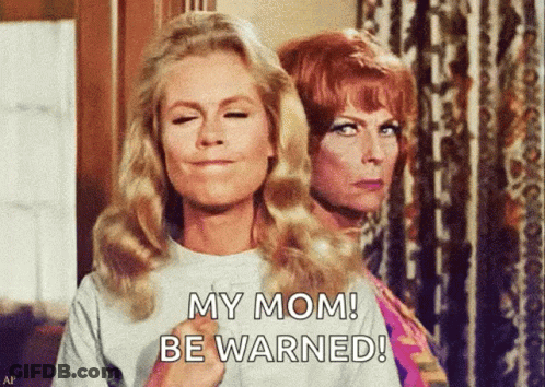 Two Women Are Standing Next To Each Other With One Saying My Mom Be Warned GIF