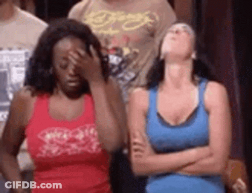 Two Women Are Standing Next To Each Other With Their Arms Crossed And One Woman Is Covering Her Face . GIF