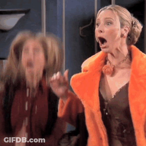 Two Women Are Standing Next To Each Other With Their Mouths Open . One Of The Women Is Wearing A Fur Coat . GIF