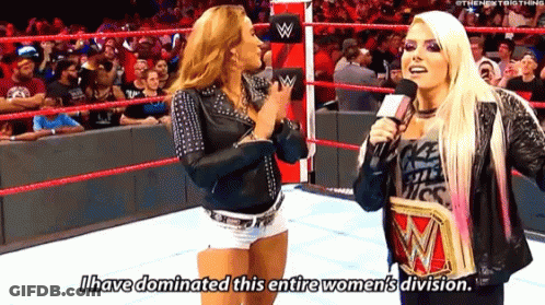 Two Women Are Talking In A Wrestling Ring And One Of Them Is Holding A Wrestling Championship . GIF