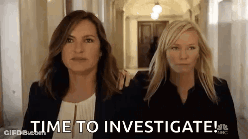 Two Women Are Walking Down A Hallway And One Of Them Is Holding The Other 'S Arm . GIF