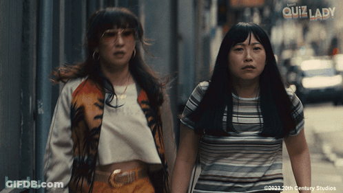 Two Women Are Walking Down A Street And The Words Quiz Lady Are On The Bottom GIF