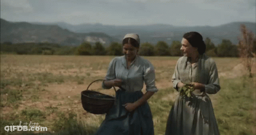 Two Women Are Walking In A Field With The Words " Gifs About Life " Written On The Bottom GIF