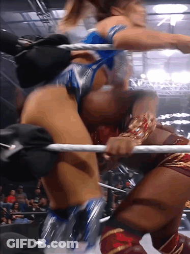 Two Women Are Wrestling In A Ring And One Of Them Has A Bracelet On Her Wrist GIF