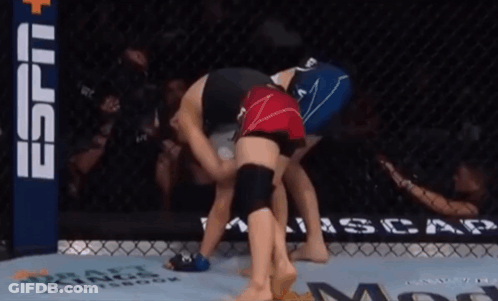 Two Women Are Wrestling In A Ring With A Espn Banner In The Back GIF