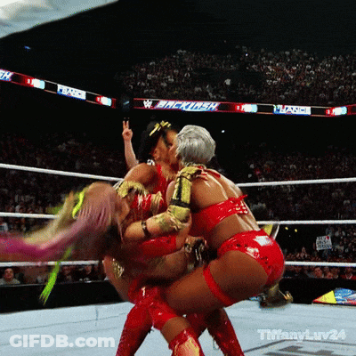 Two Women Are Wrestling In A Ring With A Sign That Says ' Backlash ' In The Background GIF