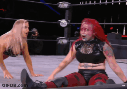 Two Women Are Wrestling In A Ring With Aew Written On The Side GIF