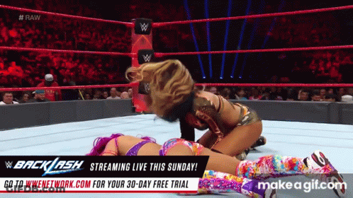 Two Women Are Wrestling In A Wrestling Ring With An Advertisement For Backlash GIF
