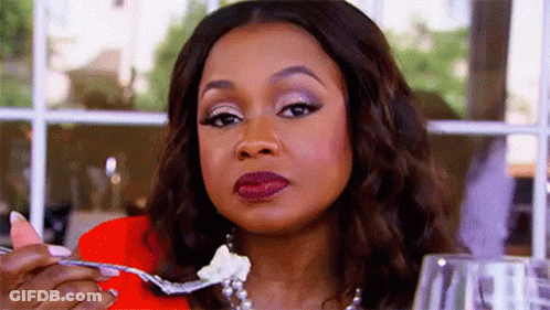 Two Women At Table One With Drink GIF