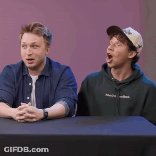 Two Women At Table With Coach Sweatshirt GIF