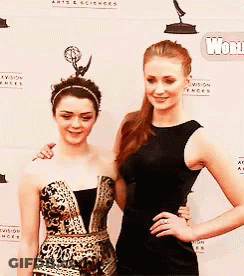 Two Women Beside Arts And Sciences Wall GIF