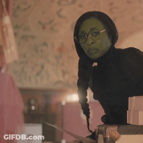 Two Women Beside Each Other One In Green Mask GIF
