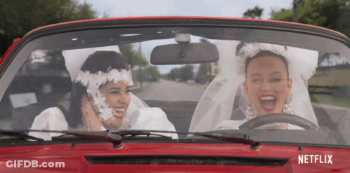 Two Women Bride And Groom Driving Red Car With Netflix GIF
