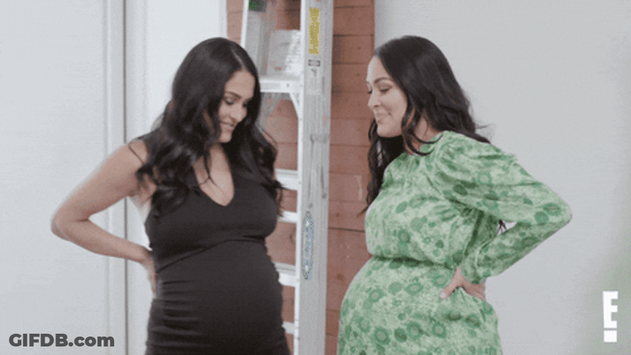 Two Women Bumps Their Pregnant Belly GIF