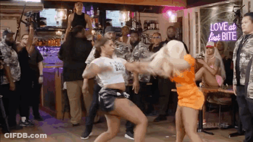 Two Women Dancing At Love At Last Bite Neon Sign GIF