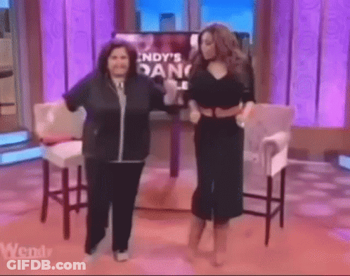 Two Women Dancing By TV With Indy's Dance GIF