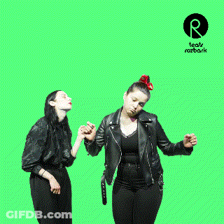 Two Women Dancing In Front Of A Green Screen That Says Teatr Rozbark On It GIF