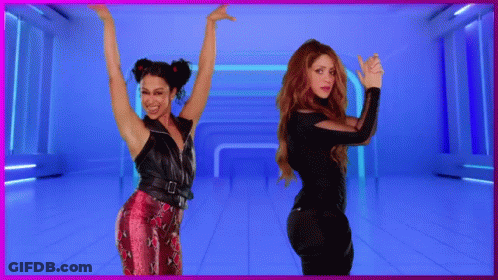Two Women Dancing In Front Of A Sign That Says Meow GIF