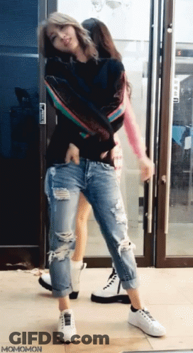Two Women Dancing In Front Of Glass Door Momomon GIF
