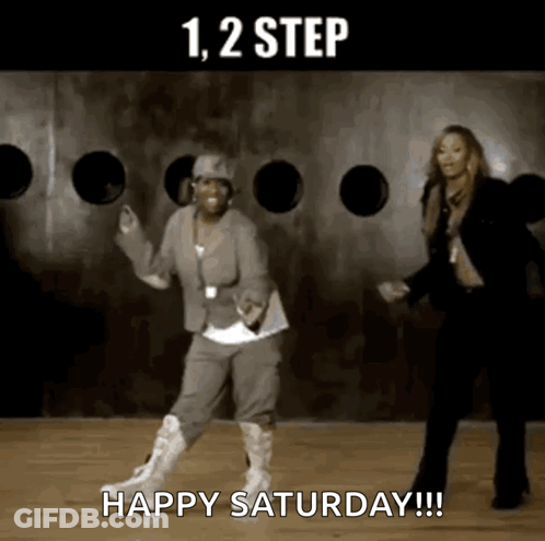 Two Women Dancing In Front Of Happy Saturday Wall GIF