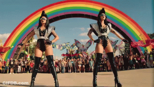 Two Women Dancing In Front Of Rainbow GIF