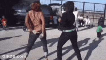 Two Women Dancing In Parking Lot GIF
