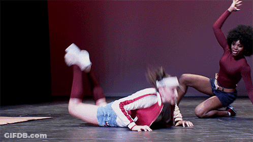 Two Women Dancing On Stage One Kneeling One Laying GIF