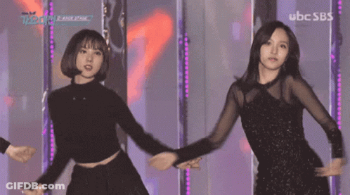 Two Women Dancing On Stage With UBC SBS GIF