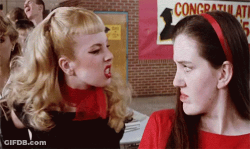 Two Women Fighting In Front Of Congratulations Sign GIF