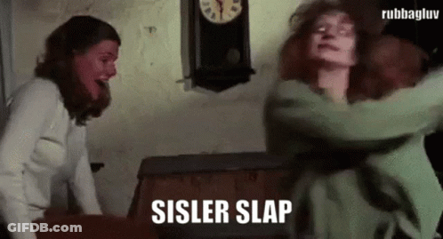 Two Women Fighting Near Clock GIF