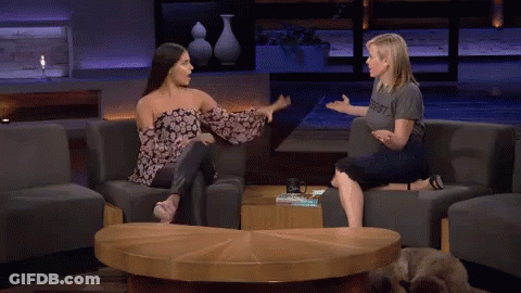 Two Women High Fiving In Resist Shirts GIF
