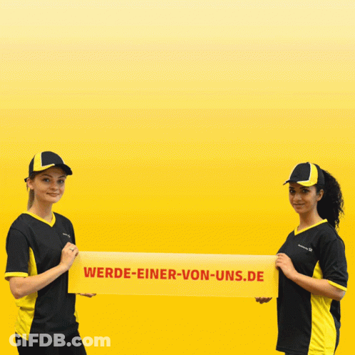 Two Women Holding A Yellow Banner That Says Wende-Einer-Von-Und GIF