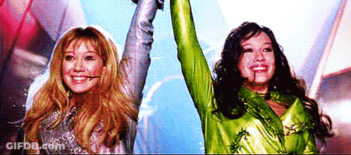 Two Women Holding Arms In The Air GIF