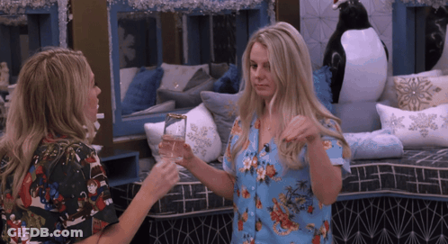 Two Women Holding Glasses GIF