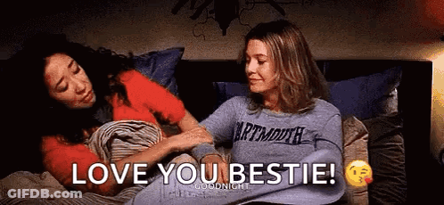 Two Women Holding Hands And Talking On Bed GIF
