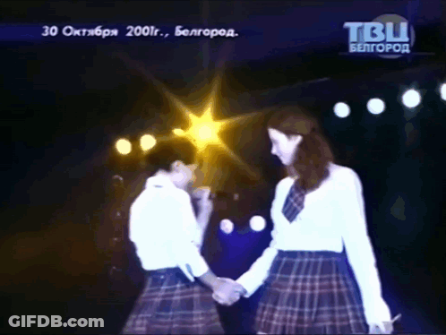 Two Women Holding Hands On Stage With TBU Logo GIF