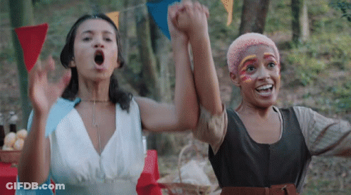 Two Women Holding Hands With Face Paint GIF