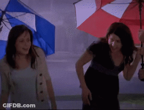 Two Women Holding Umbrellas In The Rain GIF