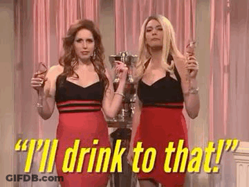 Two Women Holding Wine Glasses And Trophy GIF