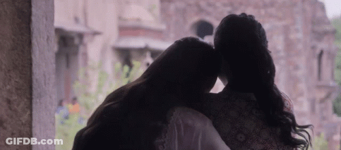 Two Women Hugging In Front Of Window GIF