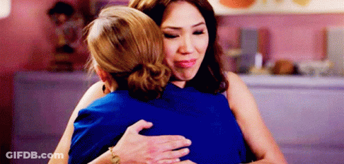Two Women Hugging In Restaurant GIF