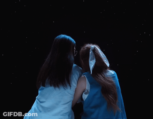 Two Women Hugging In Starry Night Sky GIF
