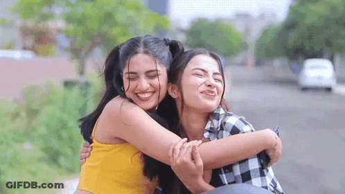 Two Women Hugging On Bench GIF