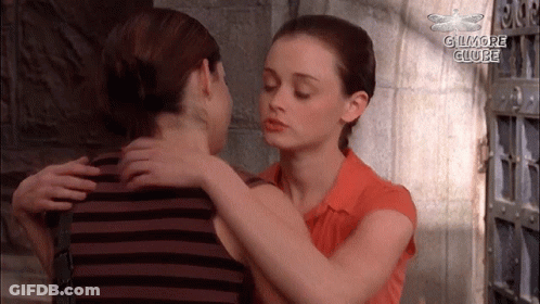 Two Women Hugging With The Words Gilmore Clube In The Corner GIF