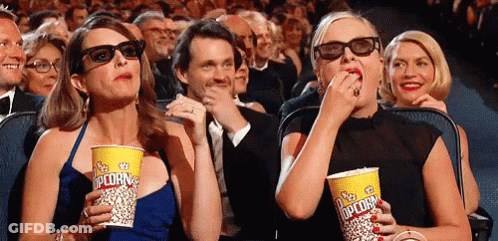 Two Women In 3D Glasses Eating Popcorn GIF